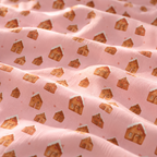 Close-up of the Pink Gingerbread House Crib Sheet fabric showing gingerbread houses on pink