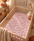 Pink Pumpkin Ghost Crib Sheet on a wooden crib mattress in a Halloween nursery