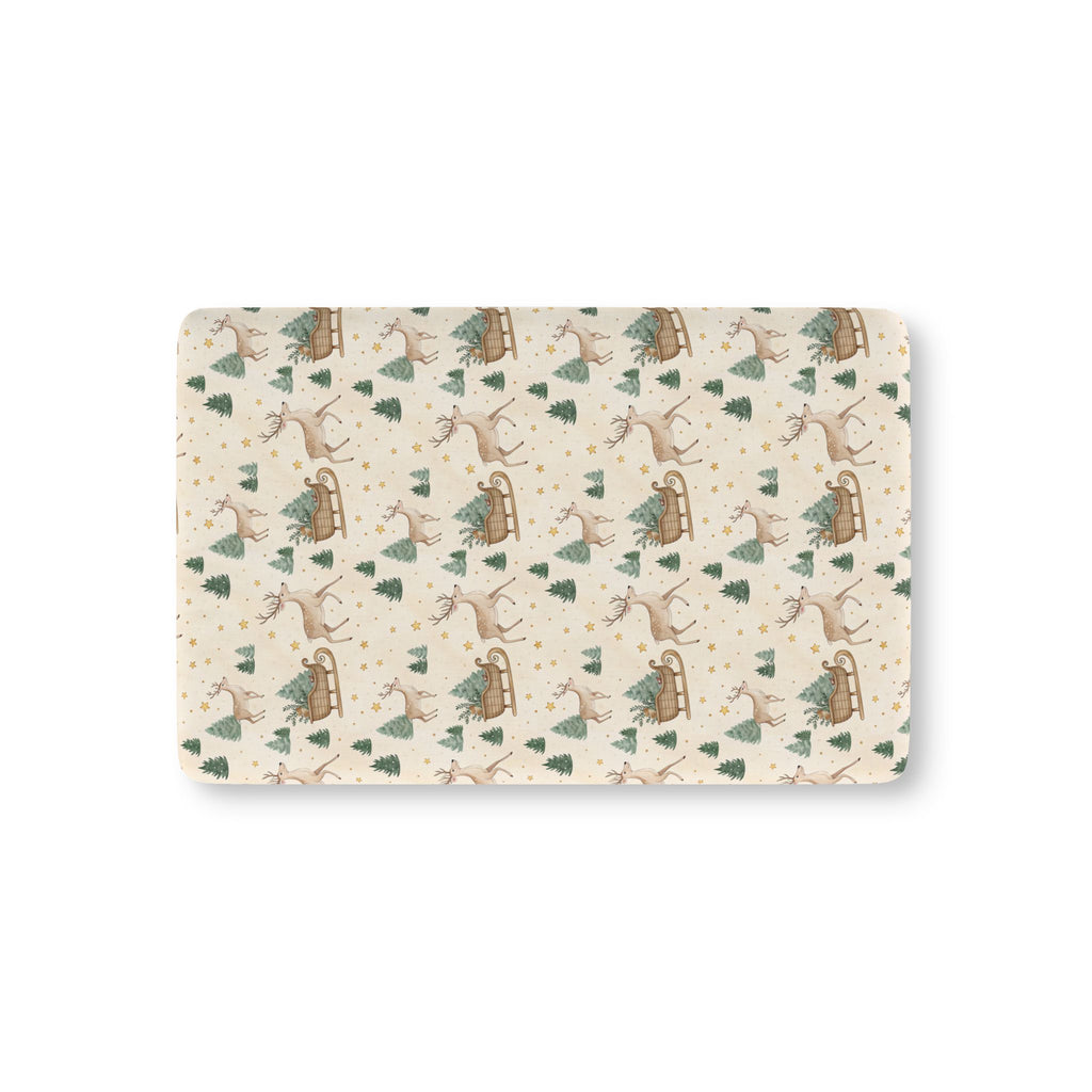 Reindeer Sleigh Crib Sheet laid flat in Mini size with reindeer, sleighs and pine trees on cream