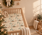 Reindeer Sleigh Crib Sheet in a wooden crib in a sunlit nursery