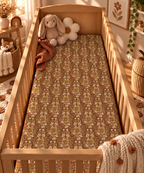 Rust Boho Floral Crib Sheet on a wooden crib mattress in a boho nursery
