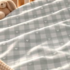 Close-up of the Sage Gingham Heart Crib Sheet fabric showing sage green gingham and tiny hearts