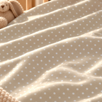 Close-up of the Sage Polka Dot Crib Sheet fabric showing white dots on sage