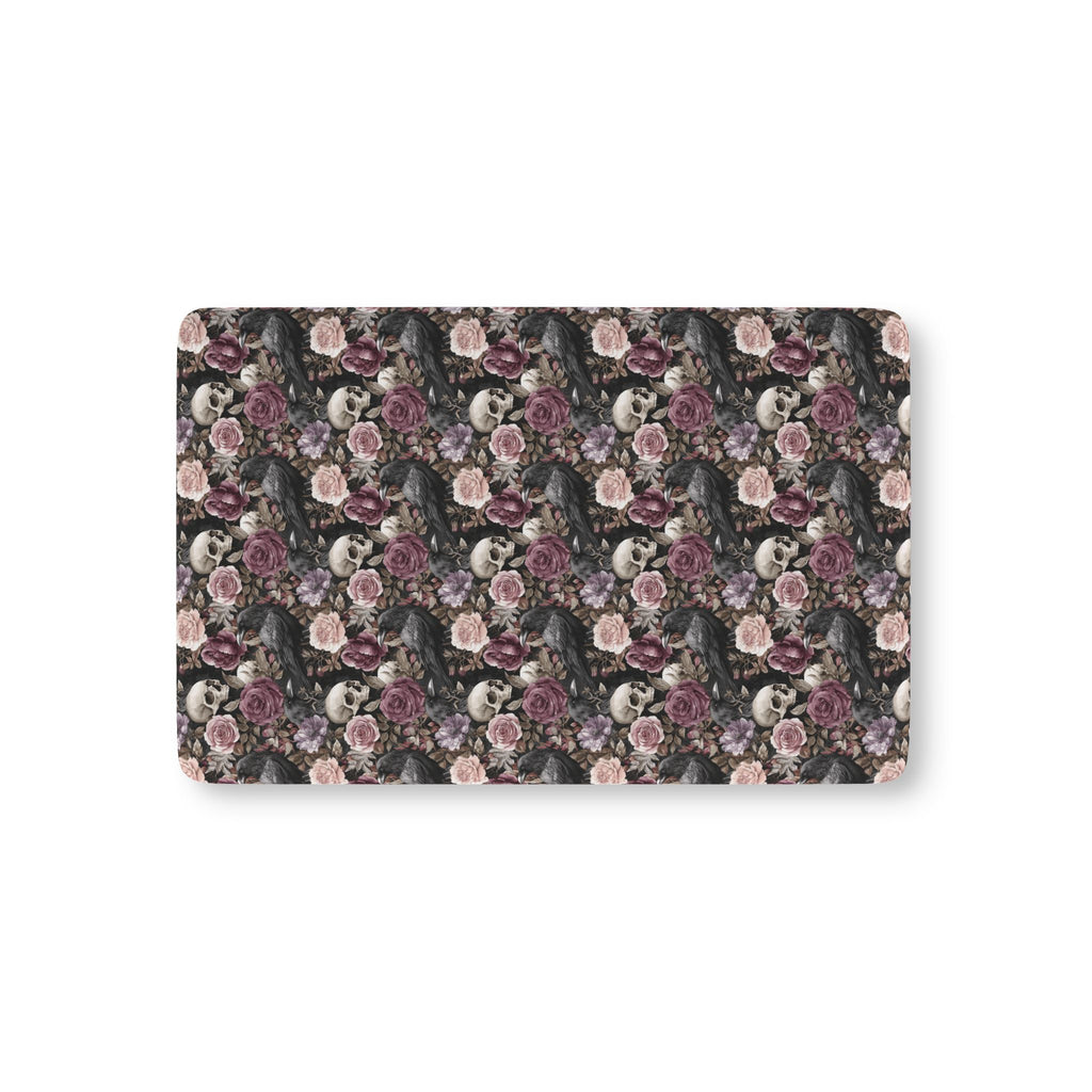 Skull Rose Crib Sheet laid flat in Mini size with skulls, ravens and dusky roses on black