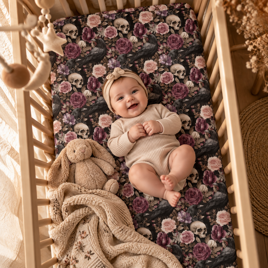 Smiling baby lying on the Skull Rose Crib Sheet