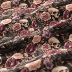 Close-up of the Skull Rose Crib Sheet fabric showing skulls, ravens and dusky roses on black