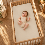 Smiling baby lying on the Solid Beige Crib Sheet