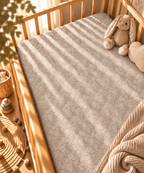 Taupe Lace Floral Crib Sheet fitted in a wooden crib with a plush toy
