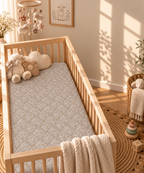 Taupe Lace Floral Crib Sheet in a wooden crib in a sunlit nursery