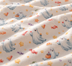 Close-up of the Watercolor Ghost Crib Sheet fabric showing dusty blue ghosts, candy and stars on pale gray