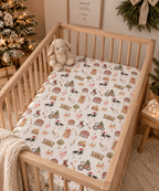 White Christmas Farm Crib Sheet on a wooden crib mattress in a Christmas nursery