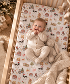 Baby lying on the White Christmas Farm Crib Sheet