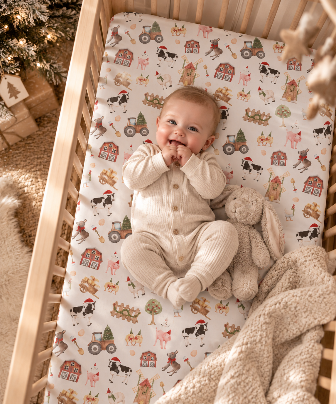 Baby lying on the White Christmas Farm Crib Sheet