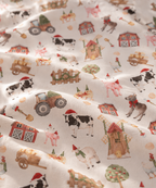 Close-up of the White Christmas Farm Crib Sheet fabric showing farm animals in Santa hats on white