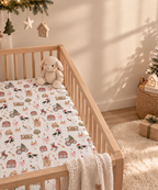 White Christmas Farm Crib Sheet in a wooden crib in a sunlit nursery