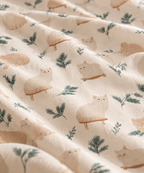 Close-up of the Winter Cat Crib Sheet fabric showing cream cats and pine sprigs on ivory