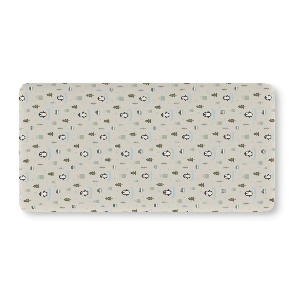 Winter Penguin Crib Sheet laid flat in Standard size with penguins and pine trees on pale sage