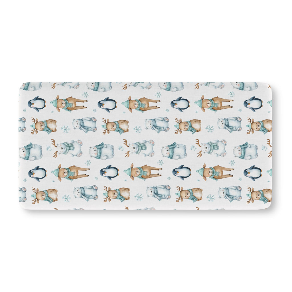 Winter Polar Bear Crib Sheet laid flat in Standard size with polar bears, penguins and reindeer in teal scarves on white